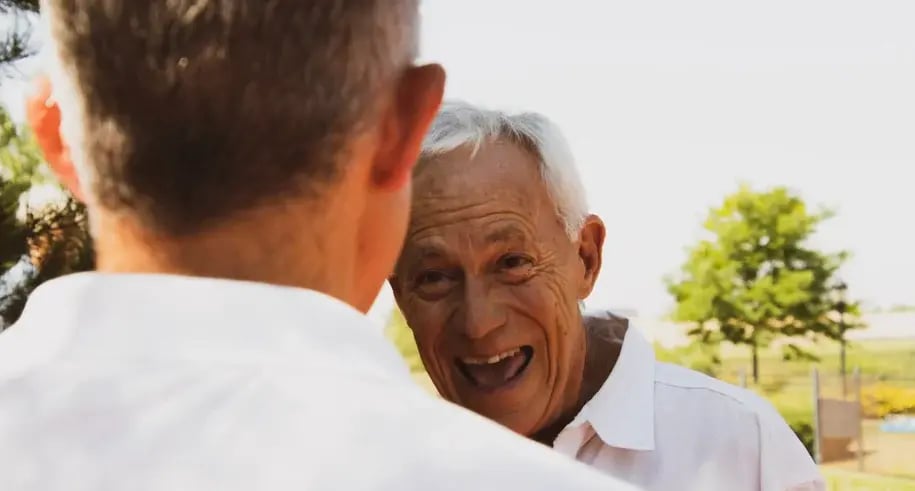Young caregiver engaging with an elderly family member in a park