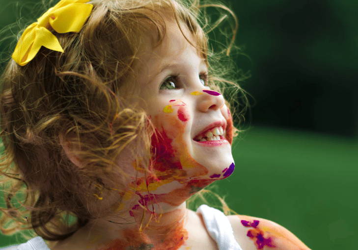 young child covered in paint